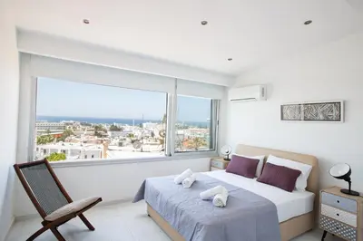 a bedroom with a bed and a large window at Rio Luxury Apartment in Ayia Napa
