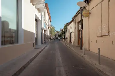 an empty street in an alley between buildings at eins rooms - city center in Limassol