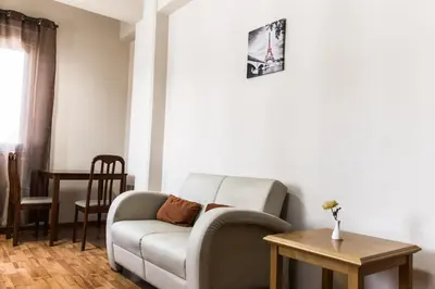 a living room with a couch and a table at Elysium Capital Residence in Nicosia