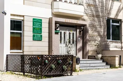 a building with a fence in front of the front door at Elysium Capital Residence in Nicosia
