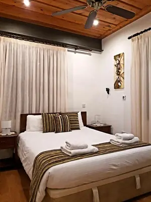 a bedroom with a large bed with towels on it at Archontiko I Misirlou in Kalopanayiotis