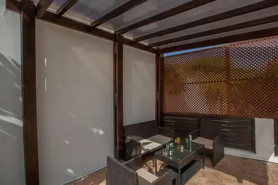 a room with a table and chairs and a window at Villa To Perivoli in Protaras