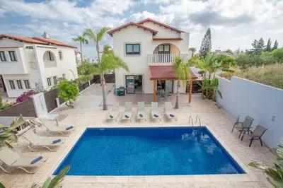 a villa with a swimming pool and a house at Villa To Perivoli in Protaras