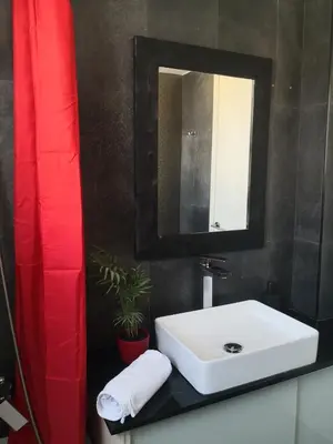a bathroom with a white sink and a mirror at Fine Designed Flat 302 in Larnaka