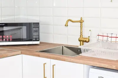 a kitchen with a sink and a microwave at Yiallos Village Apt. A101 in Meneou