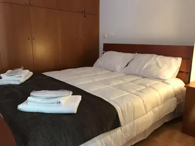 a bedroom with a bed with two towels on it at Giannoullas Luxury2Bedroom House in Kalopanagiotis in Kalopanayiotis