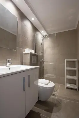 a bathroom with a toilet and a sink and a shower at Gevoni Deluxe Suites in Ayia Napa