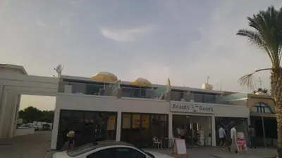 a building with people walking in front of it at Gevoni Deluxe Suites in Ayia Napa