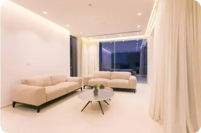 a living room with two couches and a table at Seaview Luxury Villas Ayia Napa in Ayia Napa
