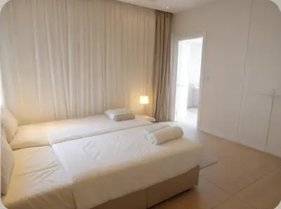 a bedroom with a large white bed in a room at Seaview Luxury Villas Ayia Napa in Ayia Napa