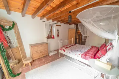a bedroom with a bed and a wooden ceiling at Madari Hills Health Retreat in Nicosia