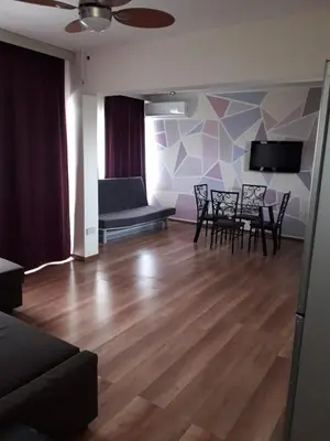 a living room with chairs and a table and a couch at 1bd next to Dasudi in Limassol