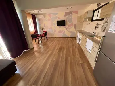a living room with a kitchen and a dining room at 1bd next to Dasudi in Limassol