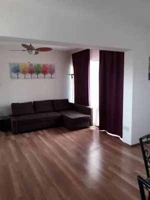 a living room with a couch and a wooden floor at 1bd next to Dasudi in Limassol