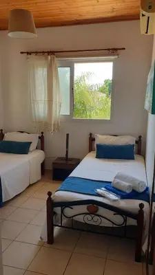 a bedroom with two beds and a window at Villa Di Gio in Paralimni