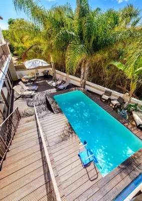 a swimming pool with a wooden deck and a swimming poolvisor at Villa Di Gio in Paralimni