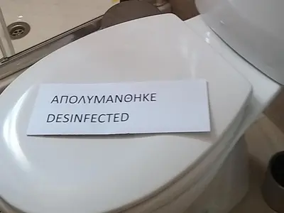 a sign on a toilet seat that reads abortionamine distracted at Ble Mavi - Studio for 2 in Vouni