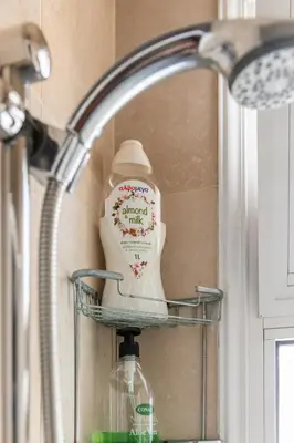 a reflection of a bottle in a bathroom mirror at Warm Residence in the heart of the City Center - Balcony & view in Nicosia