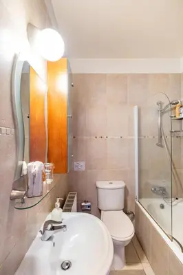 a bathroom with a sink and a toilet and a tub at Warm Residence in the heart of the City Center - Balcony & view in Nicosia