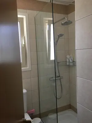 a bathroom with a shower with a glass door at Ocean View sunny retreat in Protaras