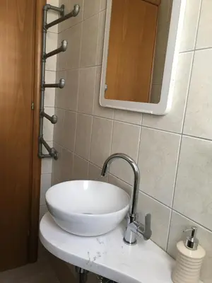 a white sink in a bathroom with a mirror at Ocean View sunny retreat in Protaras