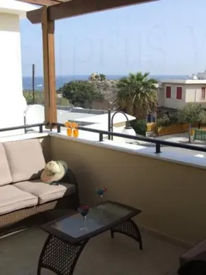 a balcony with a couch and a table with a view at Ocean View sunny retreat in Protaras