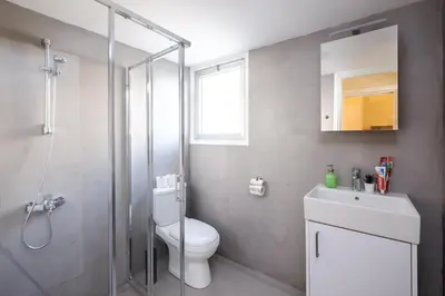 a bathroom with a shower and a toilet and a sink at The Joy - Centre One Bedroom Flat in Larnaka
