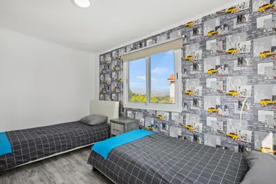 a bedroom with two beds and a window at Demetris apartment in Meneou
