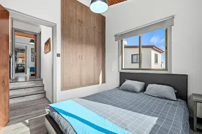 a bedroom with a bed and a large window at Demetris apartment in Meneou