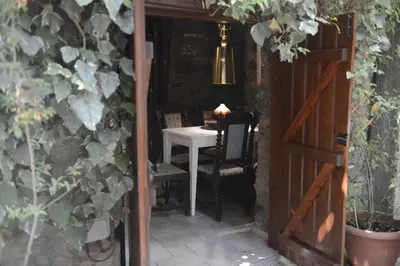 a door leading into a room with a table and a table and chair at Crambero Suites in Alona