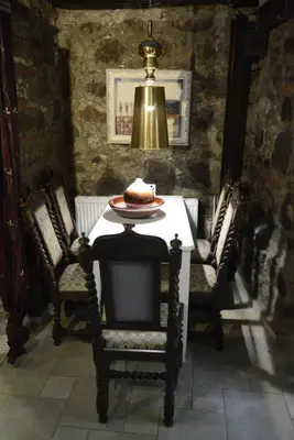a dining room with a table with a cake on it at Crambero Suites in Alona