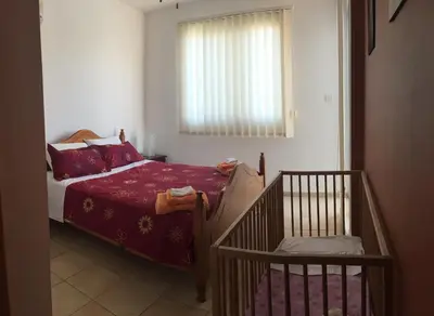 a small bedroom with a bed and a window at Villa Lola in Ayia Napa