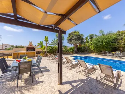a patio with a table and chairs and a pool at Angel Villa in Ayia Napa