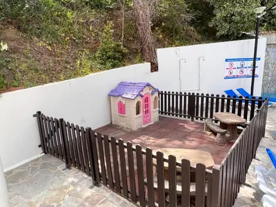a pretend play house and a bench on a patio at POED Residences in Platres