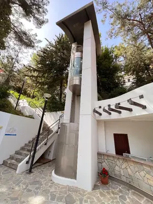a building with a spiral staircase on the side at POED Residences in Platres