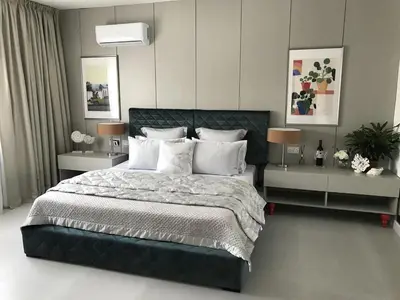 a bedroom with a large bed with two night stands at Levante Holiday Apartments in Larnaka
