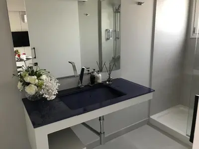 a bathroom with a blue sink and a mirror at Levante Holiday Apartments in Larnaka