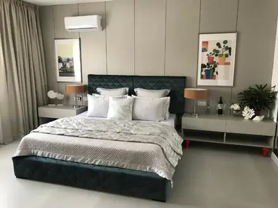 a bedroom with a large bed with two night stands at Levante Holiday Apartments in Larnaka
