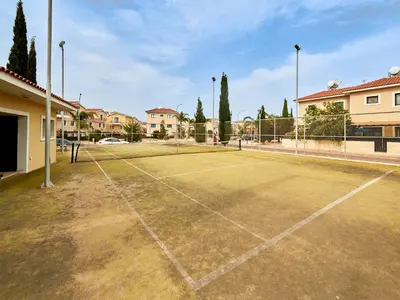 a tennis court with a net on it at Kyklades Angie Resort in Protaras