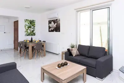 a living room with a couch and a table at Villa Rubi in Ayia Napa