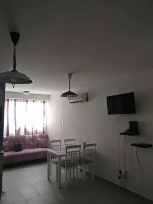 a living room with a table and a couch at Hawaii Royal Gardens in Limassol