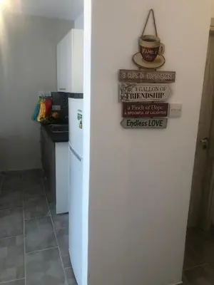 a refrigerator in a kitchen with a sign on it at AgiaNapaNest studio in Ayia Napa