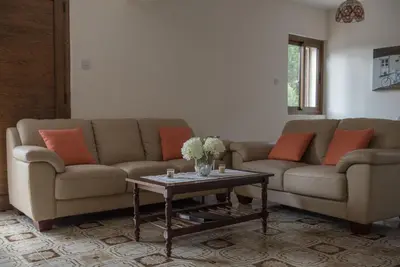 a living room with a couch and a table at Cherry Cottage in Kato Platres