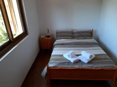 a bedroom with a bed with two towels on it at Cherry Cottage in Kato Platres