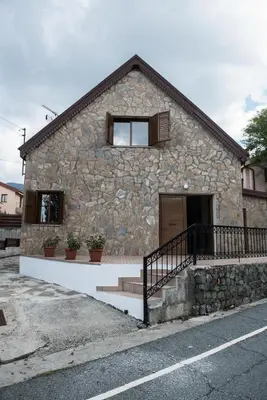 a stone building with a door and a window at Cherry Cottage in Kato Platres