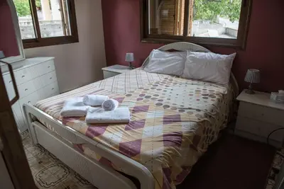a bedroom with a bed with towels on it at Cherry Cottage in Kato Platres