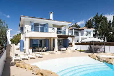 a villa with a swimming pool and a house at AAA SEAVIEW PANORAMA in Pervolia