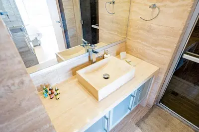 a bathroom with a sink and a mirror at AAA SEAVIEW PANORAMA in Pervolia