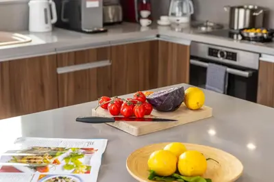 a kitchen counter with a cutting board with tomatoes and lemons at Fig Tree Bay Residences 3-Jacuzzi-Hotub -Pool in Protaras