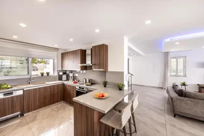 a kitchen and living room with a table and a couch at Fig Tree Bay Residences 5 in Protaras